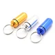 Porte-clés capsule (ici en plusieurs couleurs)